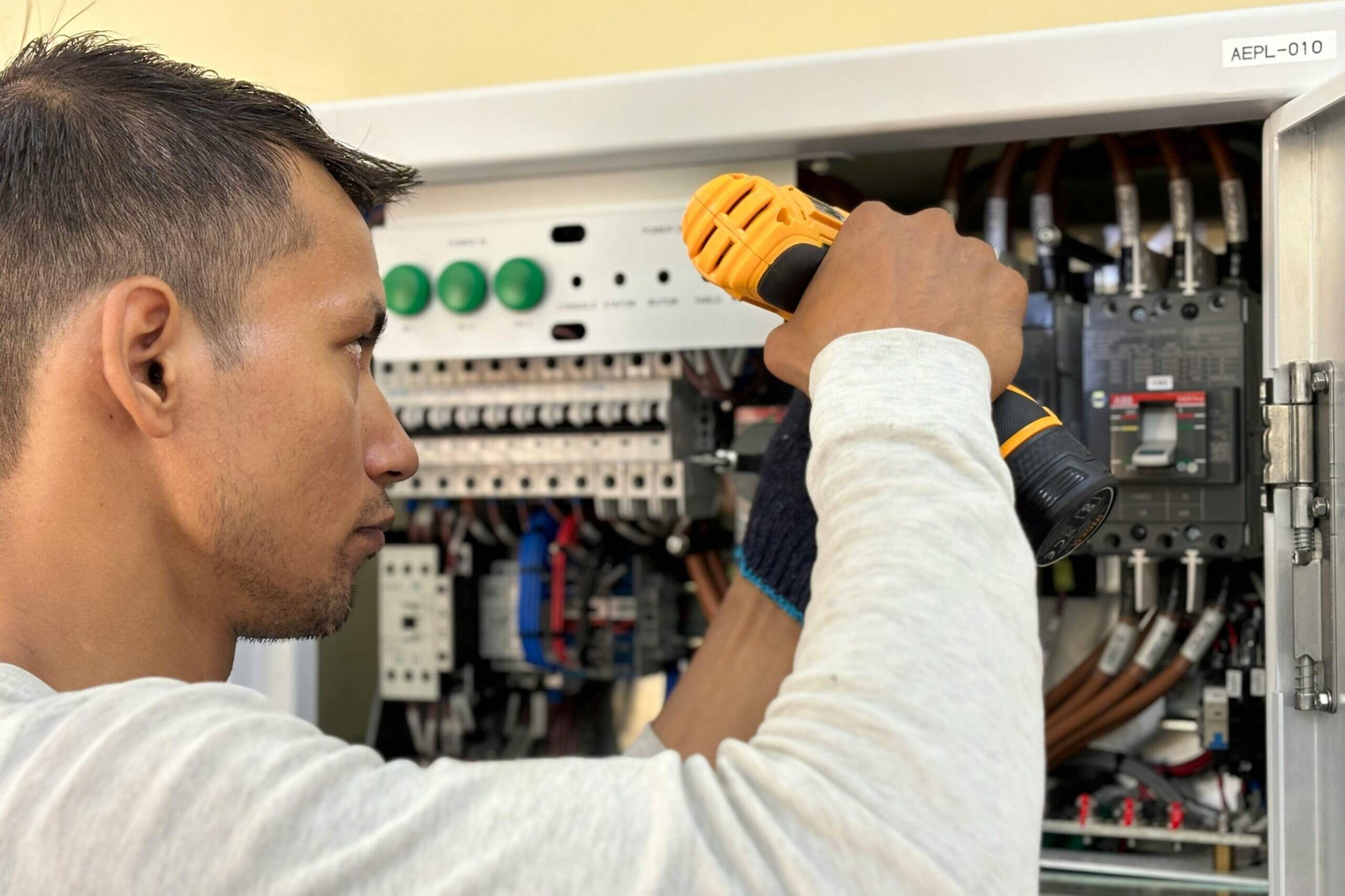 A man drilling into a power box, securing some fittings in burnley, lancashire.